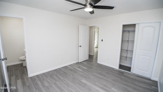 unfurnished bedroom featuring light hardwood / wood-style flooring, a closet, and ceiling fan