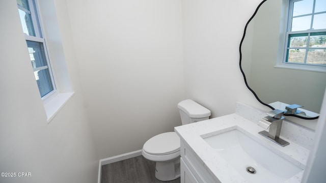 bathroom featuring vanity, hardwood / wood-style floors, and toilet