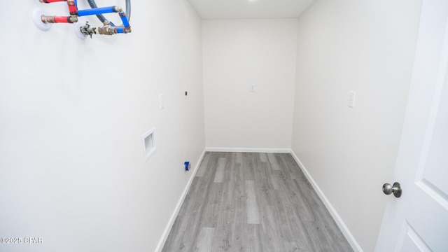 clothes washing area featuring washer hookup and light hardwood / wood-style floors