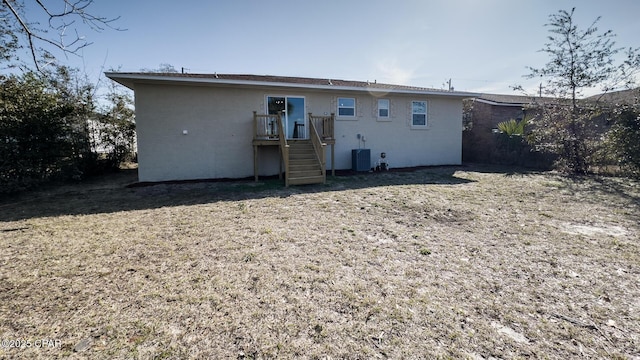 back of house with central AC unit