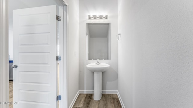 bathroom with hardwood / wood-style flooring