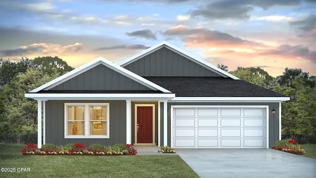 view of front of home featuring a shingled roof, board and batten siding, a front yard, a garage, and driveway