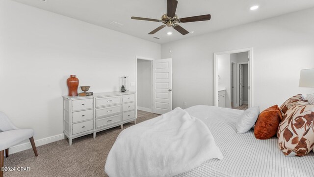 bedroom with recessed lighting, light colored carpet, a ceiling fan, ensuite bath, and baseboards