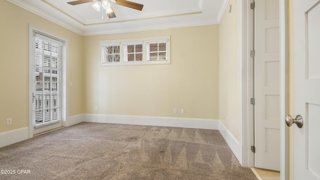 empty room featuring carpet floors, ornamental molding, and a ceiling fan