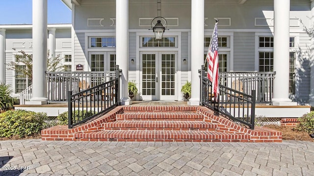 doorway to property with covered porch and french doors