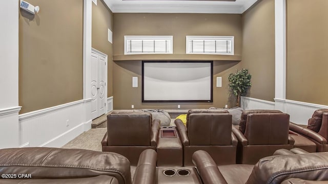 home theater room with a wainscoted wall and ornamental molding