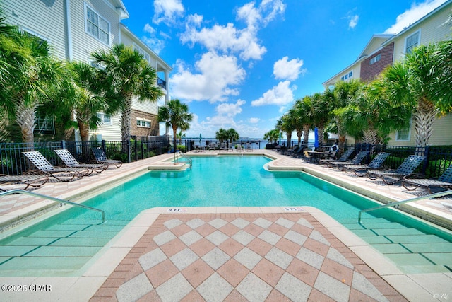 community pool featuring a patio and fence