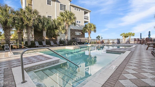 pool featuring a patio area and fence