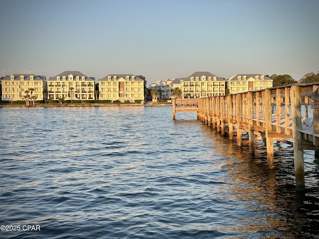 dock area featuring a water view and a residential view