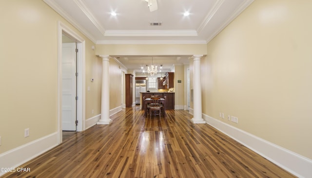 interior space with dark wood finished floors, baseboards, crown molding, and ornate columns