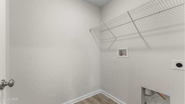 laundry room with washer hookup, electric dryer hookup, wood finished floors, laundry area, and baseboards