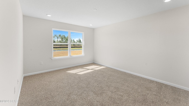 carpeted spare room with baseboards and recessed lighting