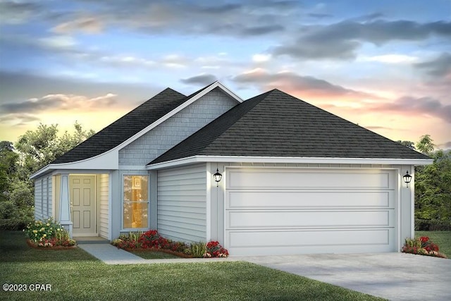 view of front of property with a garage and a lawn