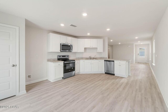 kitchen featuring sink, white cabinets, and appliances with stainless steel finishes