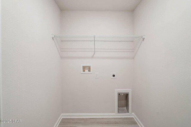 clothes washing area featuring hookup for a washing machine, wood-type flooring, and electric dryer hookup