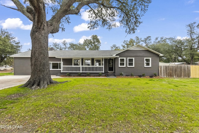 ranch-style home featuring a porch and a front yard