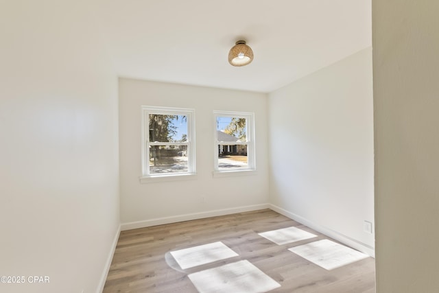 unfurnished room with light wood-type flooring