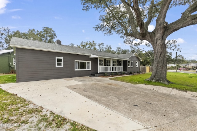 single story home with a front yard and covered porch