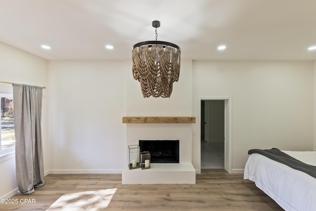 bedroom featuring hardwood / wood-style floors and a notable chandelier