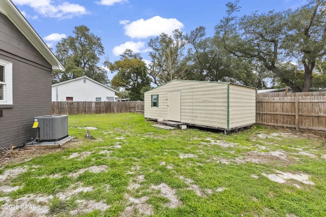 view of yard featuring central AC and a storage shed