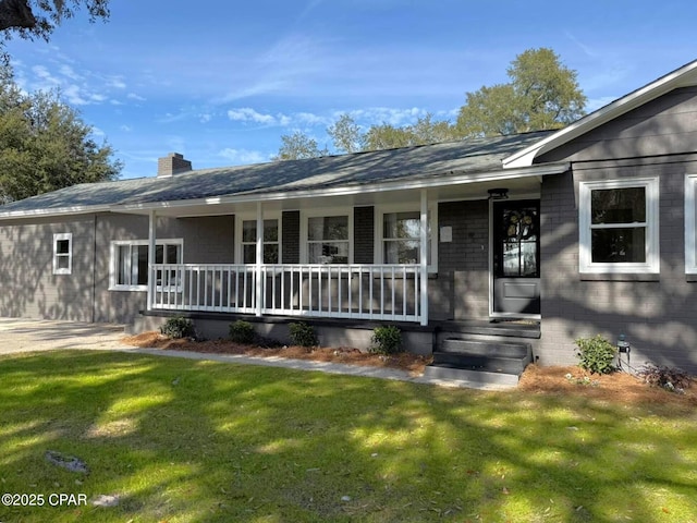 ranch-style house with a front yard and covered porch