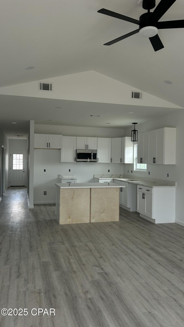 rear view of property featuring a yard and central AC unit