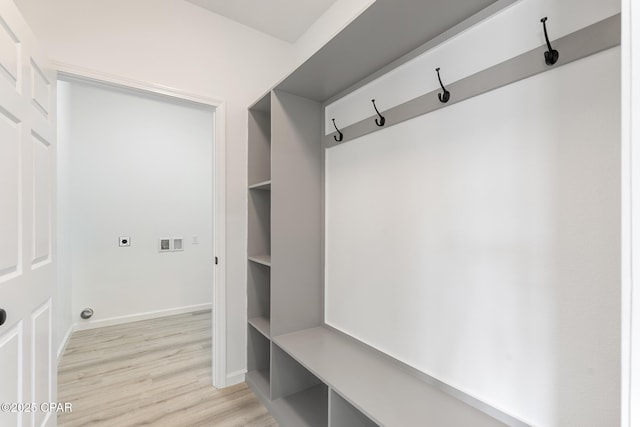 mudroom featuring light wood-style flooring and baseboards