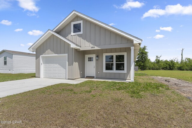 view of front of house with driveway, a front yard, board and batten siding, and a garage
