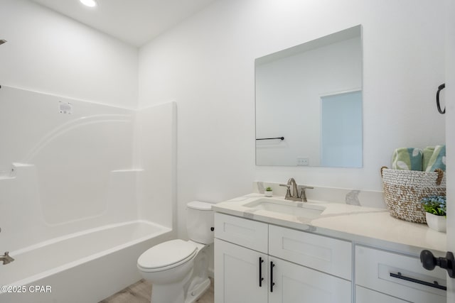 full bath with shower / bathtub combination, vanity, and toilet