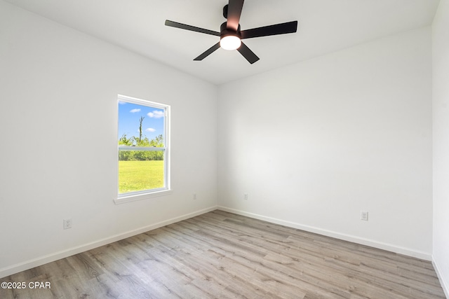 unfurnished room with wood finished floors, baseboards, and ceiling fan