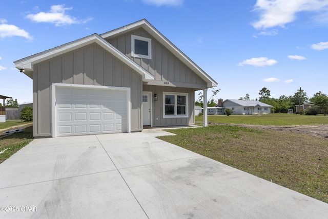 view of front of property with concrete driveway, a front yard, board and batten siding, and a garage