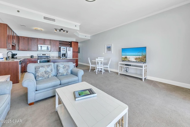 living room with light colored carpet, crown molding, baseboards, and visible vents