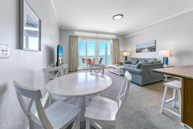 dining area featuring light colored carpet and crown molding