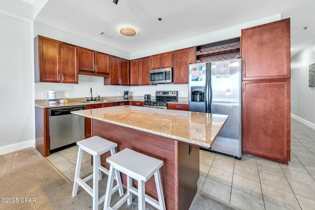 kitchen with a sink, visible vents, appliances with stainless steel finishes, and light tile patterned flooring