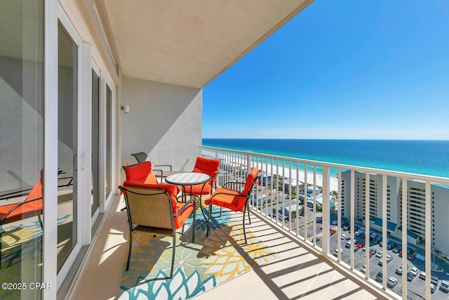 balcony with a view of the beach and a water view