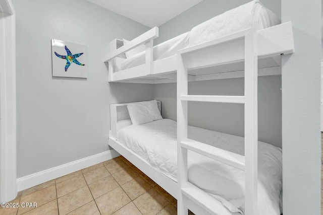 tiled bedroom featuring baseboards