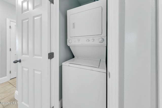 9860 S Thomas Dr Unit 2013, Panama City, FL 32408 - laundry area with stacked washer / drying machine and light tile patterned floors