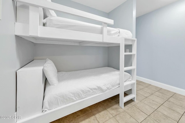 bedroom featuring tile patterned floors and baseboards