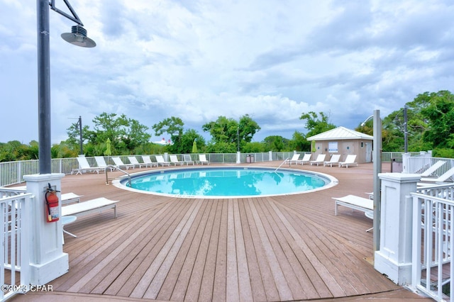 community pool with a wooden deck