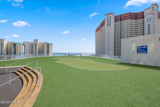 view of property's community with fence and a water view