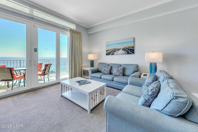 living room featuring crown molding, french doors, a water view, and light carpet