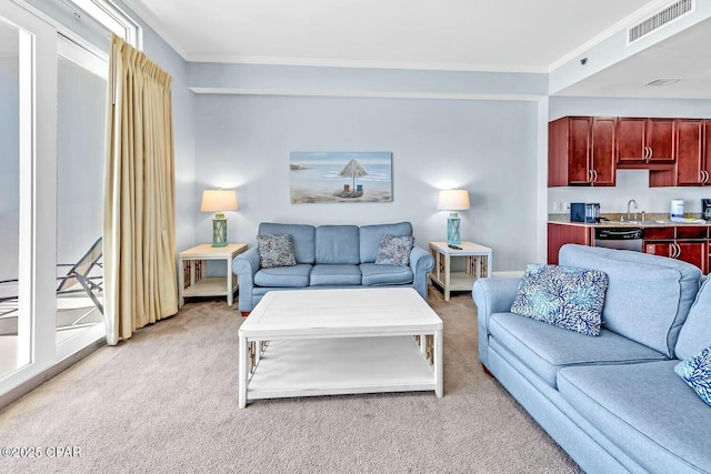 living area with ornamental molding, visible vents, and light carpet