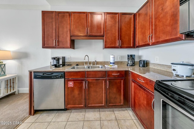 kitchen featuring light stone counters, light tile patterned flooring, a sink, dark brown cabinets, and appliances with stainless steel finishes