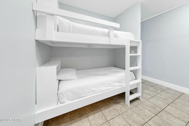 bedroom with tile patterned floors and baseboards