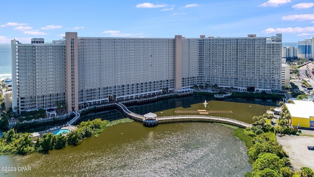 birds eye view of property with a view of city and a water view
