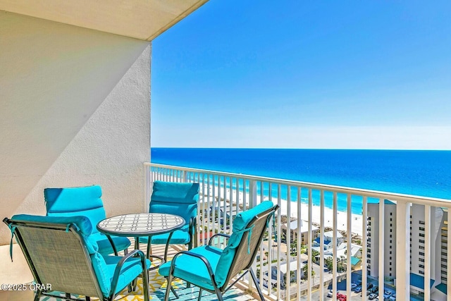 balcony with a beach view and a water view