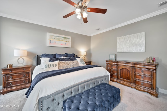 bedroom with ornamental molding, light colored carpet, and ceiling fan