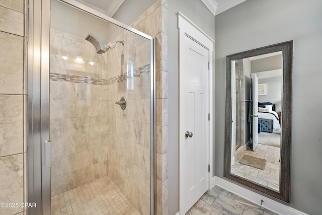 bathroom featuring ornamental molding and an enclosed shower