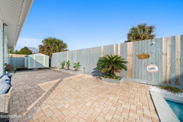 view of patio / terrace with a storage shed and a swimming pool