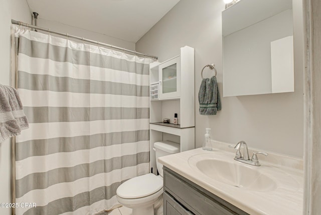 bathroom with walk in shower, vanity, and toilet